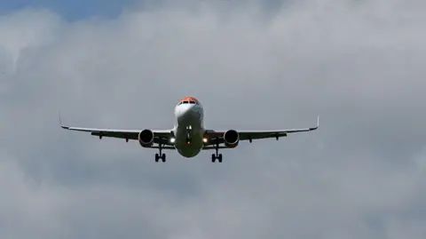 A commercial plane flying in the sky.