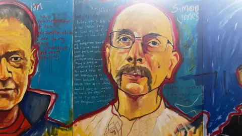 A painting profiling two different people, an older woman and an older man with glasses and a handlebar moustache. Their stories of the war in Ukraine have been painted on the blue background behind them.