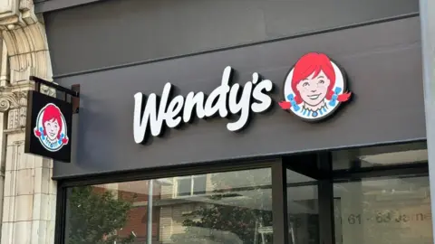 The Wendy's restaurant on Jameson Street in Hull, there is the company logo on a banner