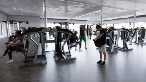 Shropshire Council/Roberts Limbrick A computer generated image of a gym, with various gym goers sat or standing near fitness machines. Windows line the back and right-hand wall.