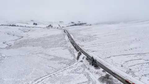 Nigel McFarland An aeriel shot of the Glenshane pass in Northern Ireland. Snow covers the surrounding fields which the road bisects. Traffic can be seen on the road