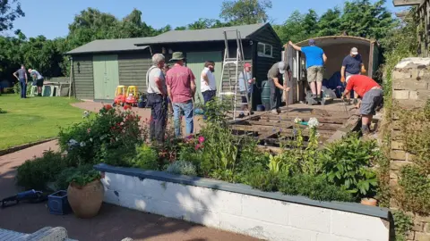 Friends of March Railway Station A group of people dismantling the railway carriage