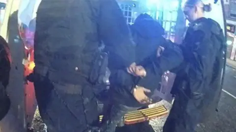 Nottinghamshire Police An image of a man being arrested by two police officers in Nottingham