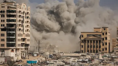 Reuters Smoke rises following an Israeli air strike that destroyed a high-rise building in Gaza City, northern Gaza (8 September 2025)
