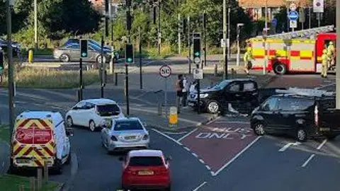 Barton Park Residents An American-style pickup has come to a stop at the crossing. A fire engine is in attendance.