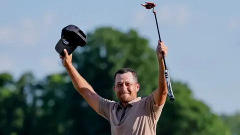 Xander Schauffele of the US reacts after sinking a birdie putt on the 18 green to win the 2024 PGA Championship