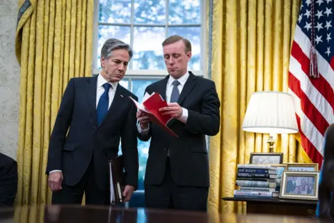 Getty Images Antony Blinken (L) speaks with Jake Sullivan (R), in the White House in a photo taken in 2023 