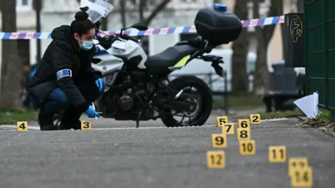 Getty Images Image shows a forensic police worker collecting evidence following a knife attack in Mulhouse, eastern France, on 22 February, 2025