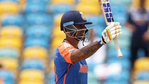 India's Suryakumar Yadav raises his bat after reaching fifty against Afghanistan