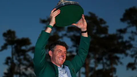 Rory McIlroy lifts the Masters trophy