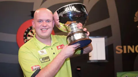Getty Images Michael van Gerwen holding the 2016 Grand Slam of Darts trophy