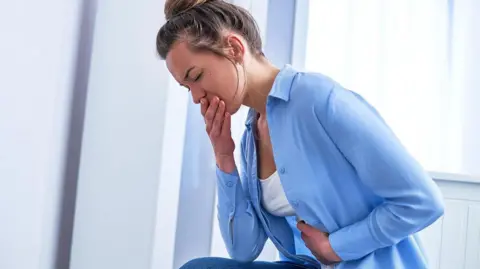 Getty Images Woman with stomach pains