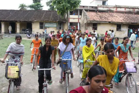 Getty Images: Girls walk out of Desari High School in Vaishali district of Bihar on bicycles provided under the state government's bicycle scheme.