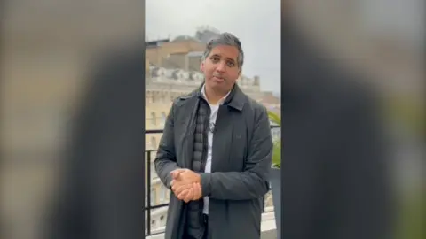 Faisal Islam wearing black.