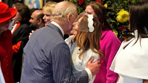 PA Media King Charles embraces Geri Horner at the end of the annual Commonwealth Day service 