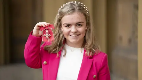 Kirsty O'Connor/PA Wire Maisie Summers-Newton with her MBE