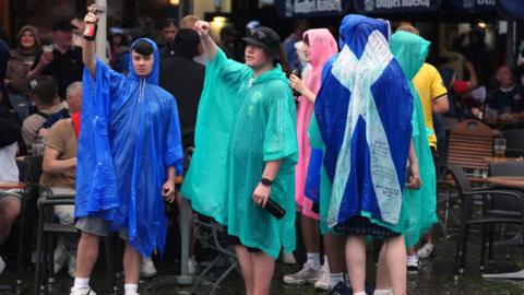 Scotland fans wearing ponchos in Cologne during Euro 2024