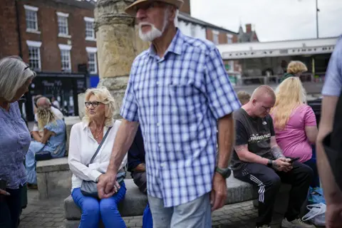 Getty Images Shoppers go about their daily chores in Selby market place