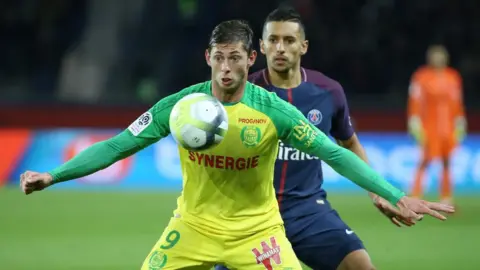 Getty Images Emiliano Sala holds off PSG defender Marquinhos