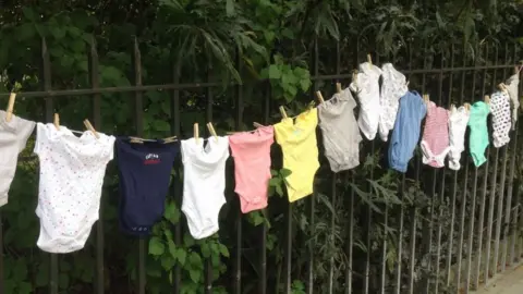 Sands baby's clothes on a washing line