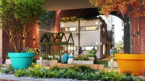 EmbassyVillage An image of people sat in a green communal area proposed as part of the scheme