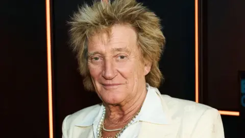 Rod Stewart pictured in the BBC Radio 2 studio in 2025, wearing a white shirt