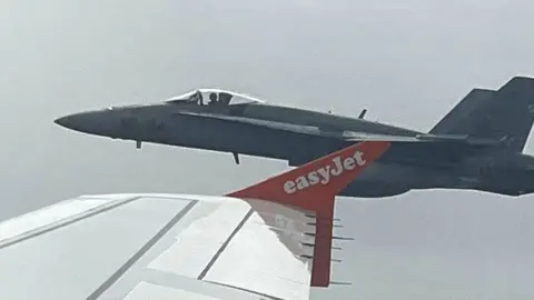 One of the two Spanish F18 fighters seen through the window of the Easyjet flight from London to Menorca