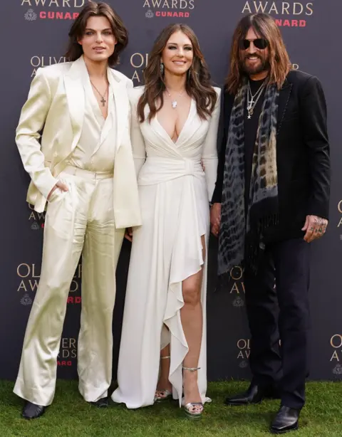 PA Media Damian Hurley, Elizabeth Hurley and Billy Ray Cyrus attending The Olivier Awards at the Royal Albert Hall, London. The annual awards recognise excellence in London theatre. Picture date: Sunday April 12, 2026