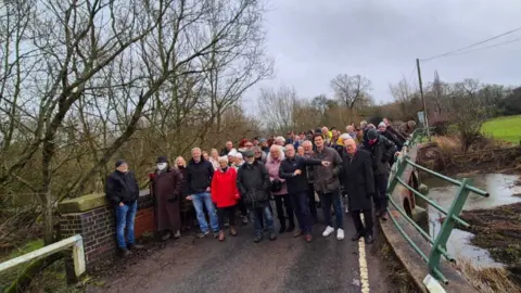 LDRS A group of men and women stood on Barston Bridge