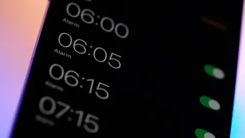A mobile phone screen with four different alarms 