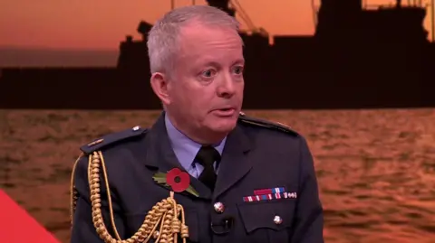 A screenshot showing Sir Richard Knighton - dressed in an RAF senior officers uniform and wearing a poppy - while he spoke to the BBC's Laura Kuenssberg.