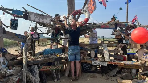 Natalie Bell / BBC Finishing touches being made to the Buck Beck Beach bench.