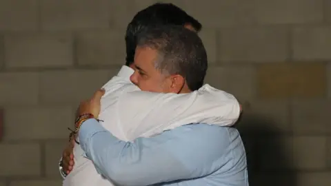 Reuters Guaidó embraces Colombia's President Ivan Duque