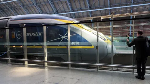 A man seen standing next to a Eurostar trais in London St Pancras station