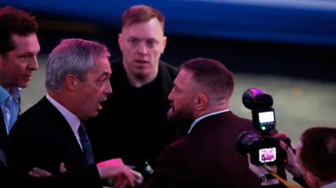 Reuters British politician Nigel Farage and Irish MMA fighter Conor McGregor talk at a Trump rally on Sunday  