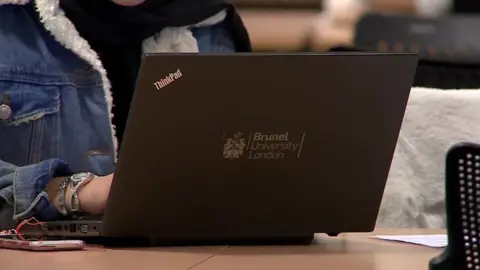 File image of an anonymous young woman using a Brunel-branded laptop on campus.