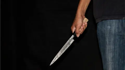 Getty Images Stock image of a person with a knife