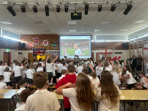 Schoolchildren watching the England match