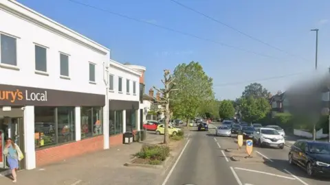A google street view of Worplesdon Road, with a Sainsbury's Local on the right