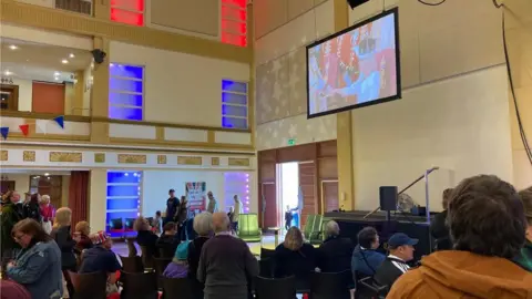 Phillip Norton / BBC People watch the Coronation at Bridlington's Steam Punk festival