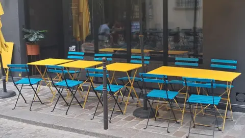 James Fitzgerald / BBC A row of empty dining tables