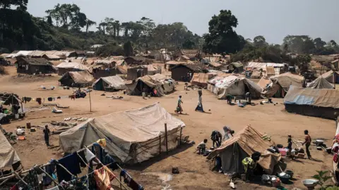 Getty Images January 21, 2021, shows dozens of makeshift shelters set-up by Central African refugees who fled Bangassou to Ndu, Bas-Uele Province, Democratic Republic of Congo