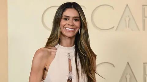 Tiktok star Taylor Frankie Paul attends the 98th Oscars on 15 March in a cream gown.