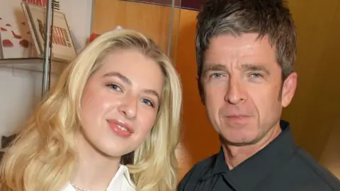 Getty Images Anais and Noel Gallagher standing together and looking at the camera