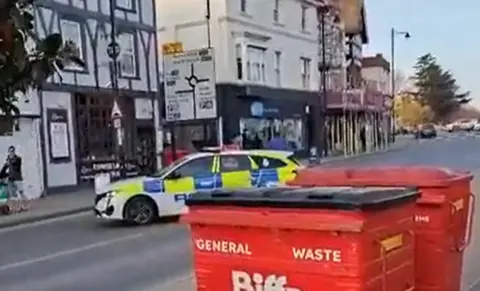 Neil Mackay screengrab from video showing police car in the road