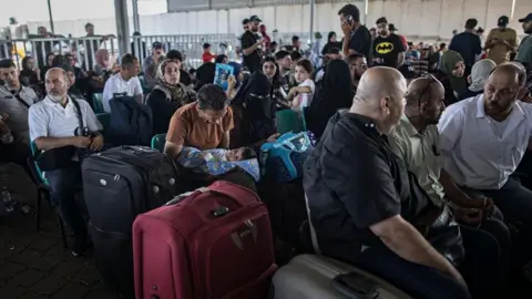 EPA-EFE/REX/Shutterstock People waiting at the Rafah crossing