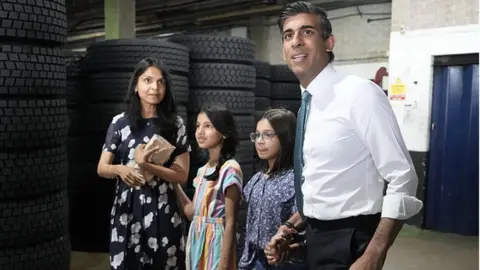 EPA Conservative Leadership hopeful Rishi Sunak with daughters Krisna, Anoushka and wife Akshata Murthy after making a speech while campaigning on July 23, 2022 in Grantham, England. Former Chancellor Rishi Sunak has chosen Grantham, a Conservative party heartland and the home town of former PM Margaret Thatcher, as the next stop of his campaign to become the leader of the Conservative party and Prime Minister