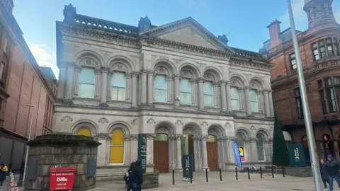2 Royal Avenue - a gothic style building made from stone. It is two floors high with windows and an entrance. 
