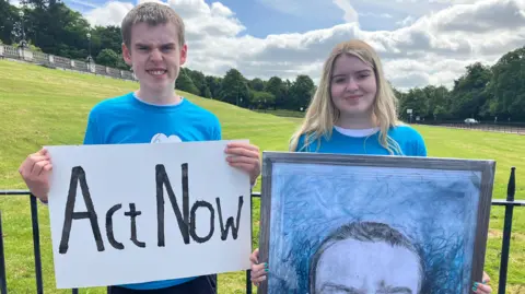 BBC Caleb and Lauren White stand outside Stormont