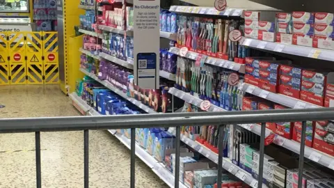 Twitter/@nicholasmith6 Railings cordoning off an area of Tesco containing sanitary products